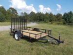 Pillowle 6’4” x 10’ carry-on utility trailer with black metal frame and open flatbed design for versatile hauling.