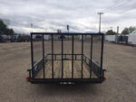 Pillowle 6’4” x 10’ carry-on utility trailer with black metal frame and open bed for versatile hauling.