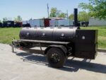 Pillowle 330-gallon pull-behind BBQ smoker with round charcoal grill on a 3500lb axle, outdoor cooking equipment in use.