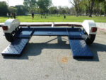 Heavy-duty Pillowle Tow Max vehicle tow dolly with 4,900 lb capacity, featuring sturdy construction and wheel straps.